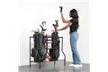 slide 2 of 4, zoom in, woman pulling golf club from bag on golf rack
